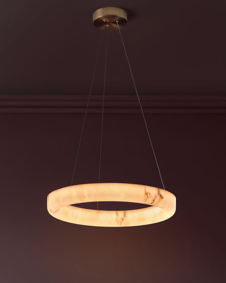 Sadie small pendant light in alabaster effect natural finish, featuring a circular ring design suspended by brass hardware.