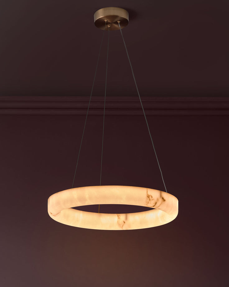 Sadie small pendant light in alabaster effect natural finish, featuring a circular ring design suspended by brass hardware.