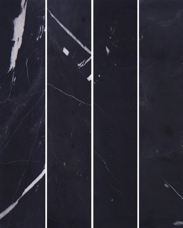 Black marble panels with white veining on display; a sophisticated and luxurious surface finish for interiors.