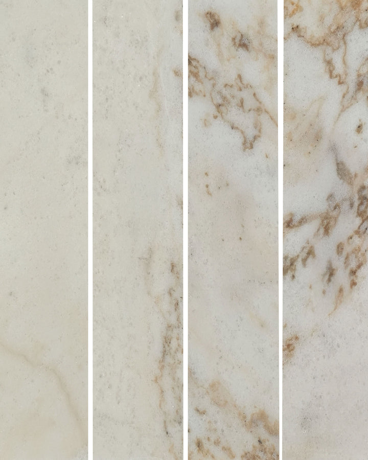 Four vertical marble tile samples showing cream and beige tones with natural veining and subtle brown accents.