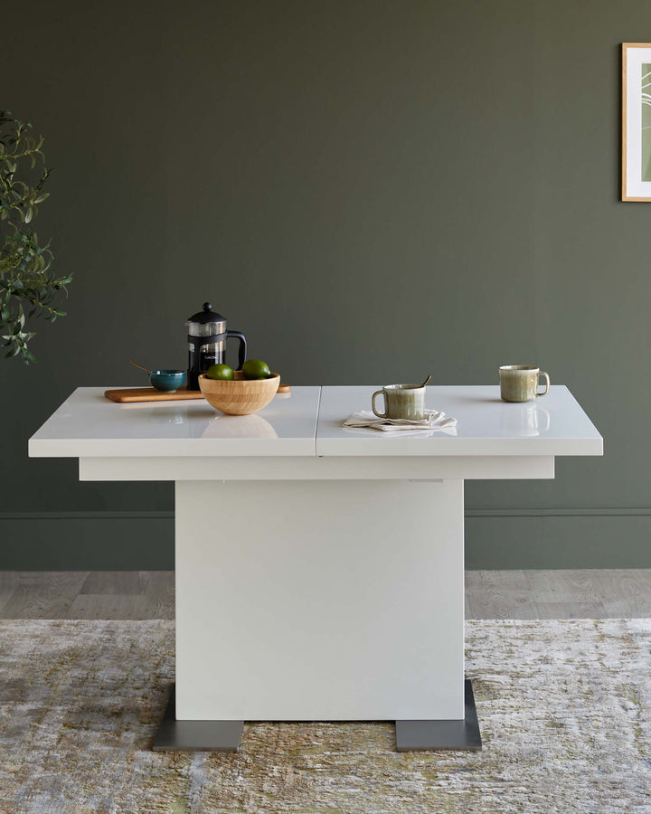 A modern white extending dining table with a square pedestal base and a high gloss finish, perfect for any dining space.
