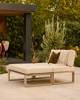 Savannah garden daybed with natural wood base and beige cushions, styled in outdoor patio setting with greenery.