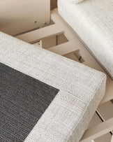 Savannah Garden daybed set in natural finish, close-up detail of cream upholstered frame with dark cushion insert.