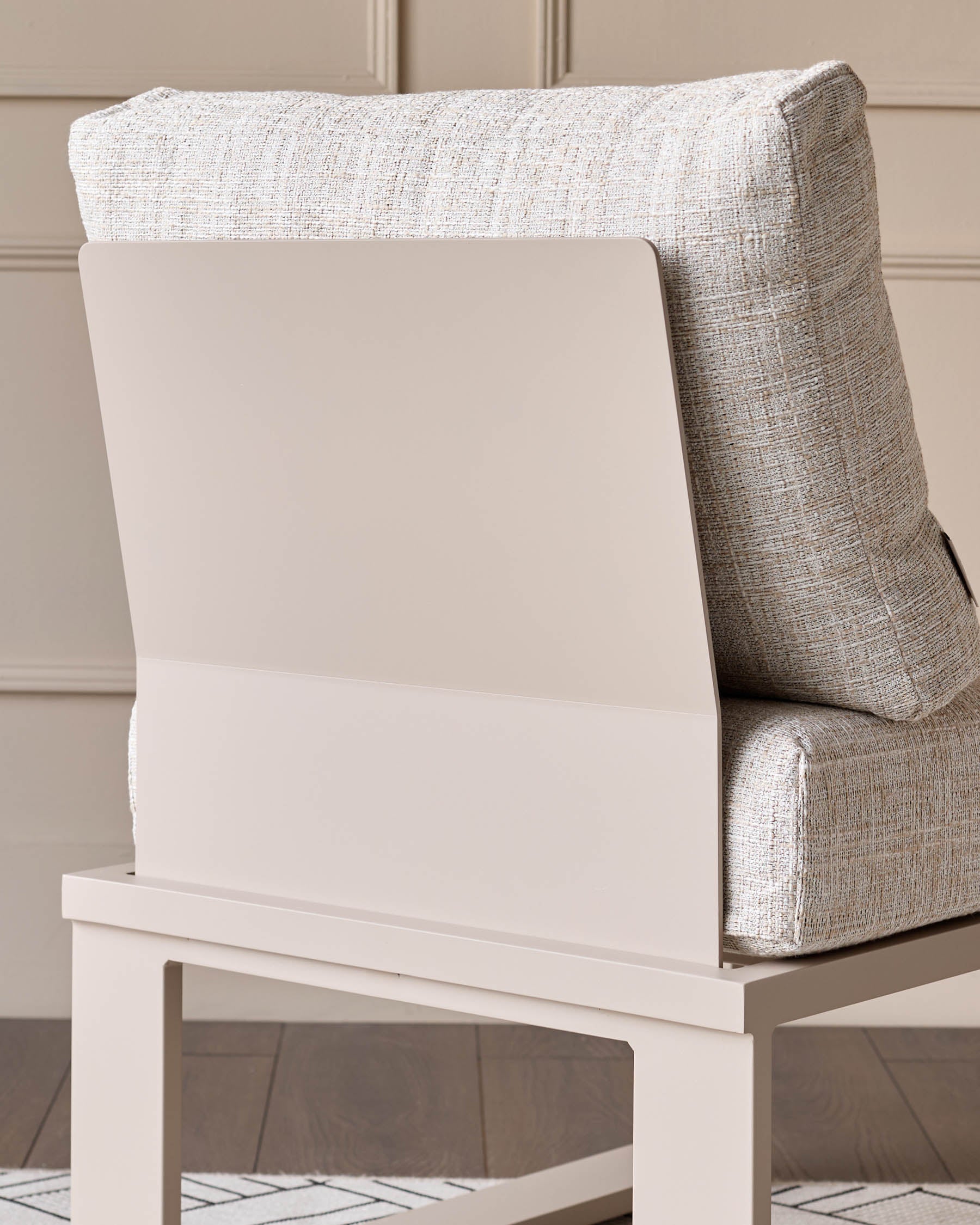 Cream upholstered armchair with natural wood frame, shown from a side angle against a neutral background.
