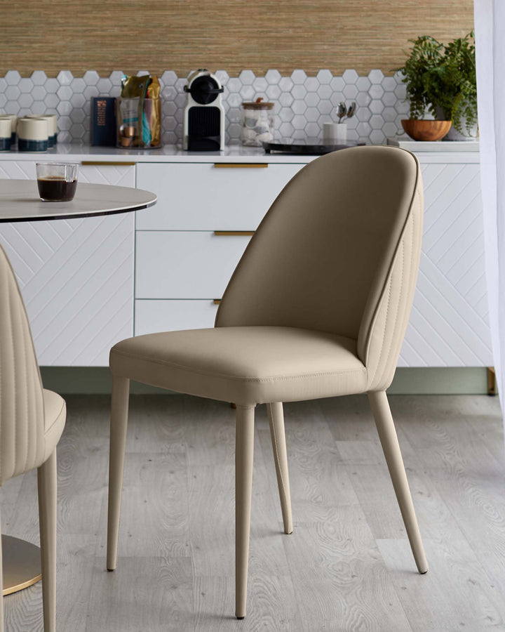 A stylish dining room featuring modern upholstered chairs with sleek, angled legs, paired with a round table.