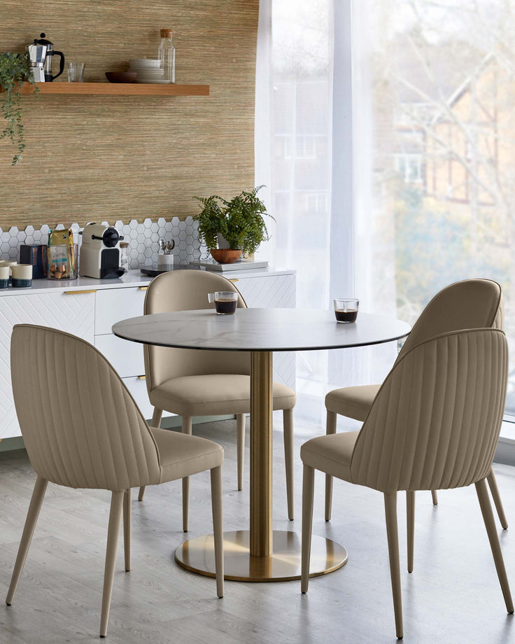 A dining table with a marble top and gold base, surrounded by four upholstered chairs with vertical stitching.