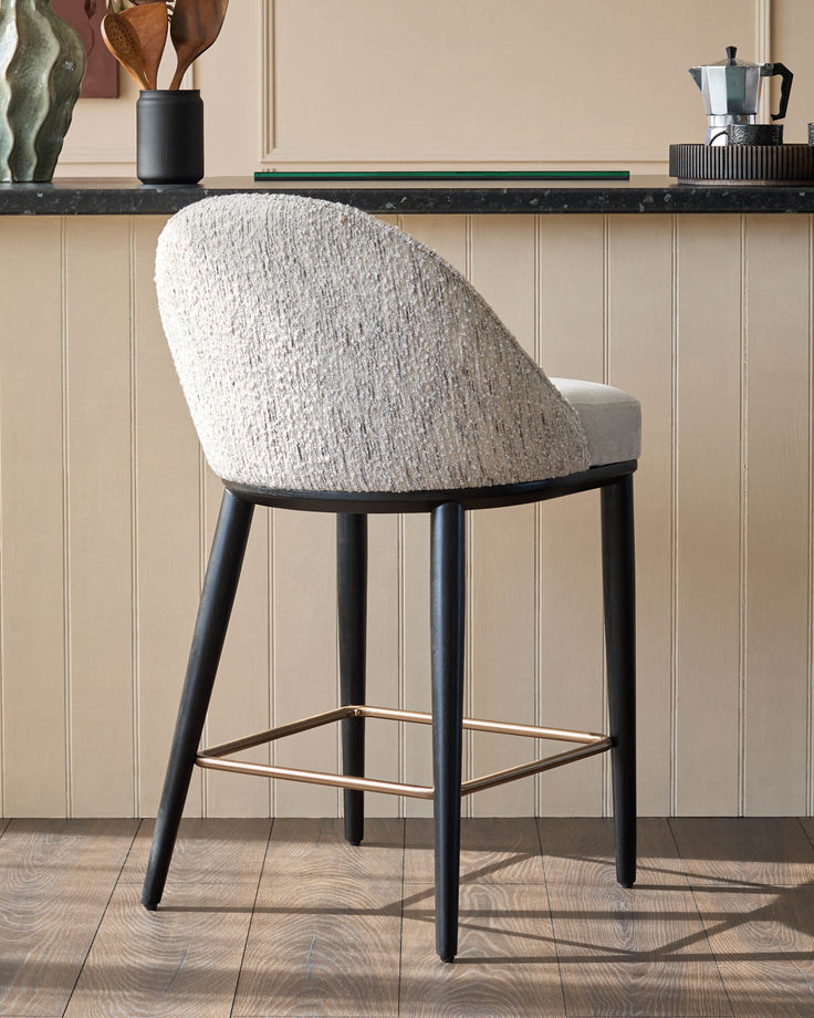 A stylish tweed bar stool with a circular back, sitting in a modern kitchen setting.