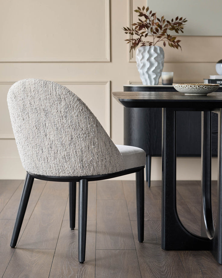 A contemporary dining set, featuring a textured chair and dark wood table, exudes modern elegance.