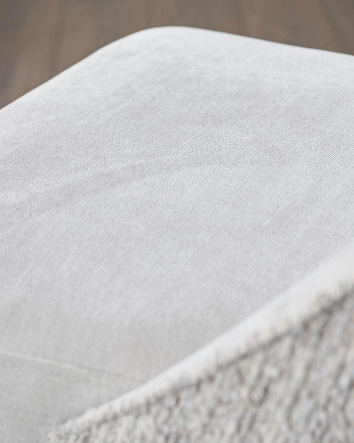 Close-up of a cream textured fabric chair, part of a stylish and comfortable furniture set.