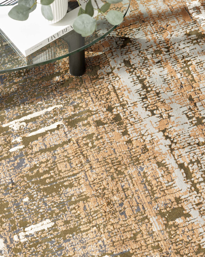 Close-up of a patterned rug underneath a glass-topped coffee table with a dark base, showcasing its unique texture.