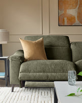 Dark green fabric 3-seater recliner sofa with extended footrest, gold cushion, and wooden legs in modern living room setting.