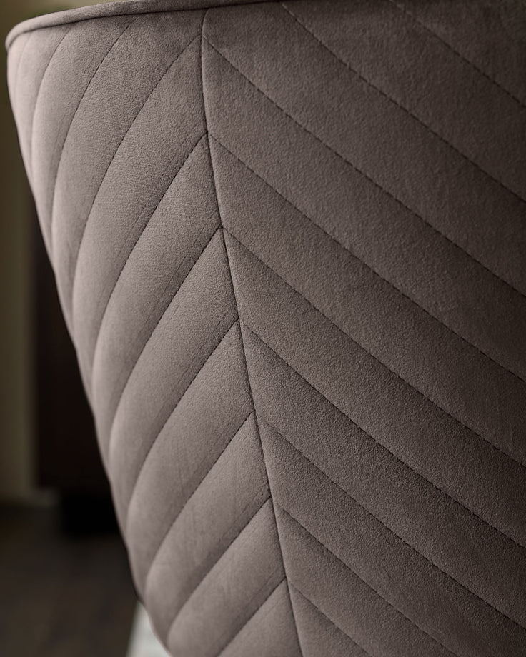 Serena Velvet Dining Chair in Mocha - Close-up of quilted backrest showing diagonal stitching pattern and soft fabric texture.
