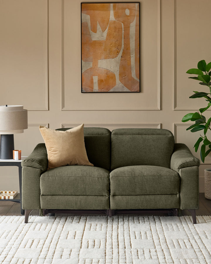 Dark green fabric 2-seater recliner sofa with rolled arms and dark legs, styled in a modern living room with neutral walls and décor.