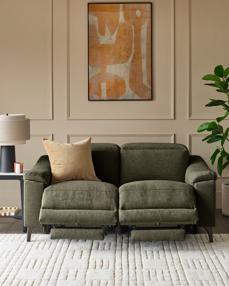 Dark green fabric 2-seater recliner sofa with footrests extended, gold cushion, in neutral living room setting.