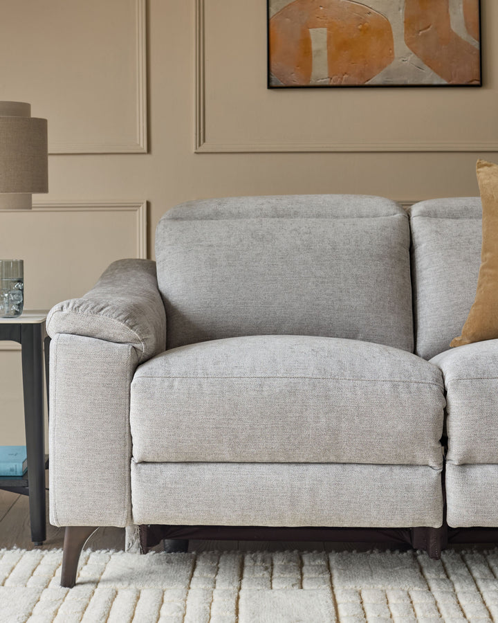 Light grey fabric 2-seater recliner sofa with rolled armrests and wooden legs, shown in a styled living room setting.