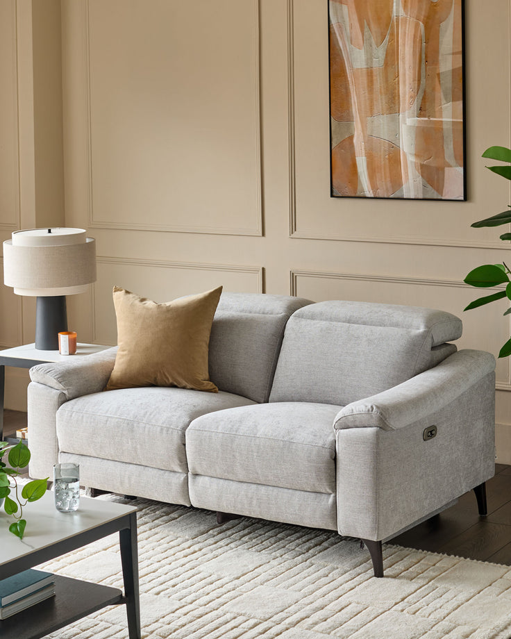 Serene 2-seater light grey fabric recliner sofa with padded armrests, displayed in a modern living room setting.