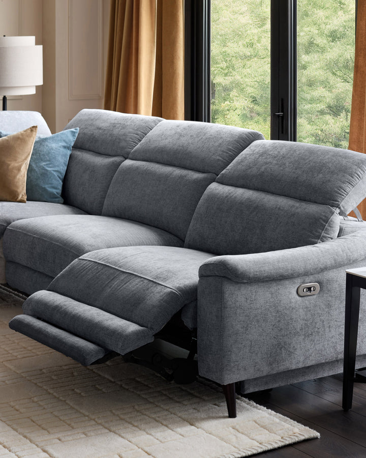 Serene left chaise recliner sofa in blue-grey chenille with footrest extended, shown in modern living room setting.
