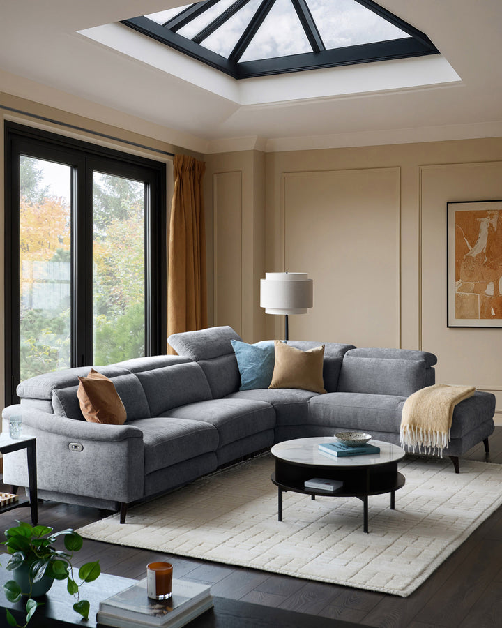 Serene right chaise recliner sofa in blue-grey chenille, displayed in a modern living room with matching accent pillows.