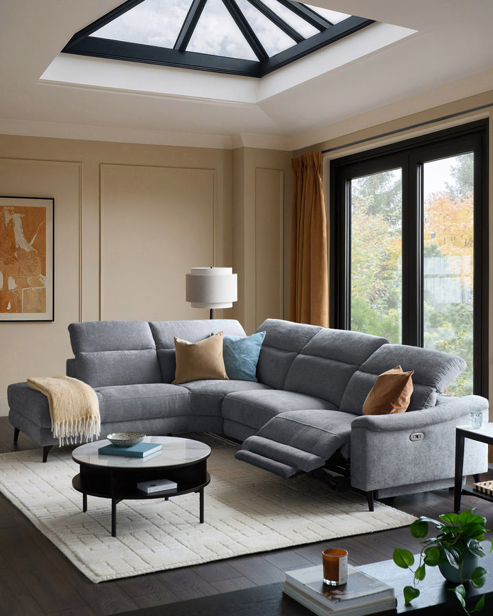 Blue-grey chenille sectional sofa with left chaise, reclining seat, and curved design in modern living room.