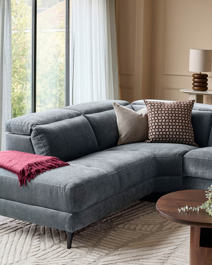 Serene left small corner recliner sofa in blue-grey fabric, styled with decorative pillows and throw blanket in a bright living room.