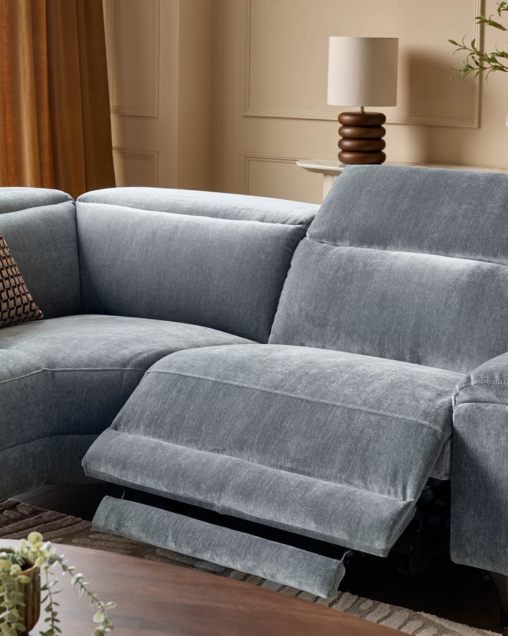 Serene left small corner recliner sofa in blue-grey fabric with footrest extended, shown in modern living room setting.