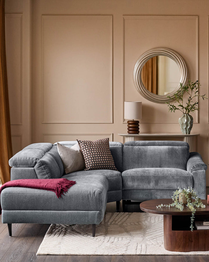 Serene left small corner recliner sofa in blue-grey fabric, displayed in a modern living room setting with cushions and throw blanket.