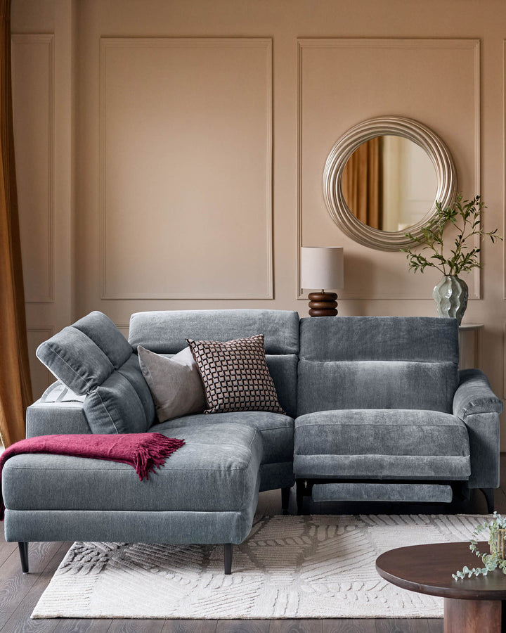 Serene left small corner recliner sofa in blue-grey fabric, styled in a modern living room with cushions and throw blanket.