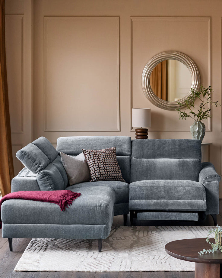 Serene left small corner recliner sofa in blue-grey fabric, styled in a modern living room with cushions and throw blanket.