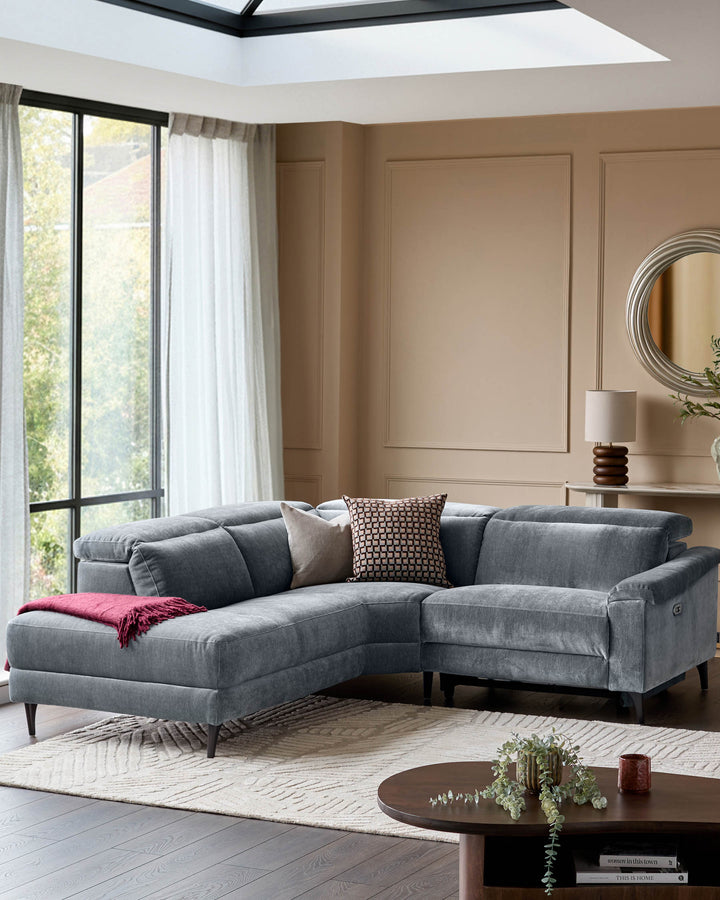 Serene left small corner recliner sofa in blue-grey fabric, displayed in a modern living room with neutral décor.