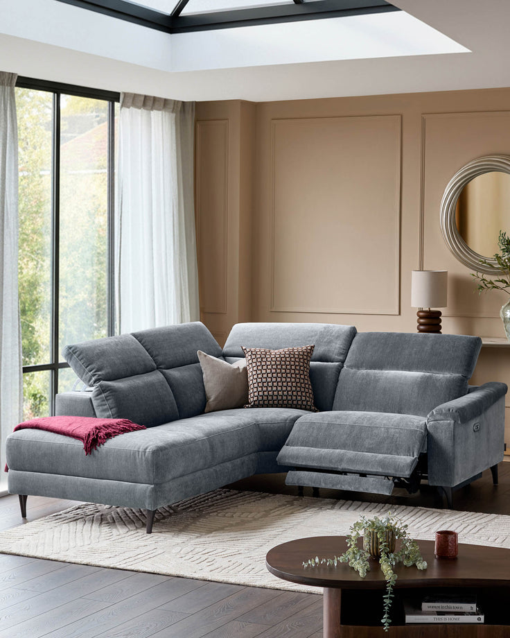 Serene left small corner recliner sofa in blue-grey fabric with extended footrest, displayed in a modern living room setting.