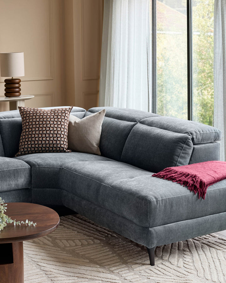 Serene right small corner recliner sofa in blue-grey fabric, styled in a modern living room with decorative pillows and throw blanket.
