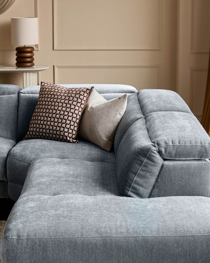 Serene right small corner recliner sofa in blue-grey fabric, styled with decorative pillows in a neutral room setting.