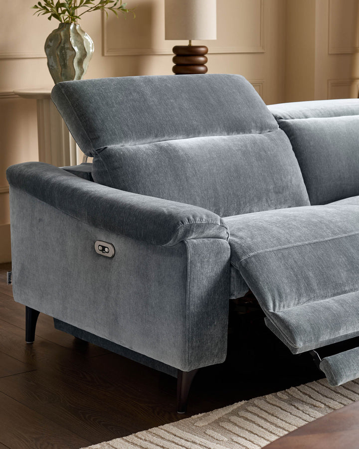 Serene right small corner recliner sofa in blue-grey fabric with extended footrest and control button visible on armrest.