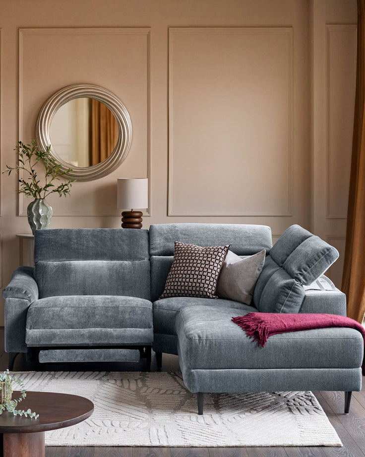 Serene right small corner recliner sofa in blue-grey fabric, displayed in a styled living room setting with decorative pillows and throw.