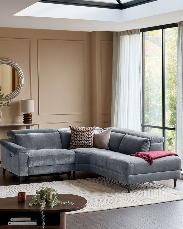 Serene right small corner recliner sofa in blue-grey fabric, displayed in a modern living room with skylight and large windows.