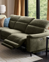 Serene left chaise recliner sofa in dark green chenille with footrest extended, shown in modern living room setting.