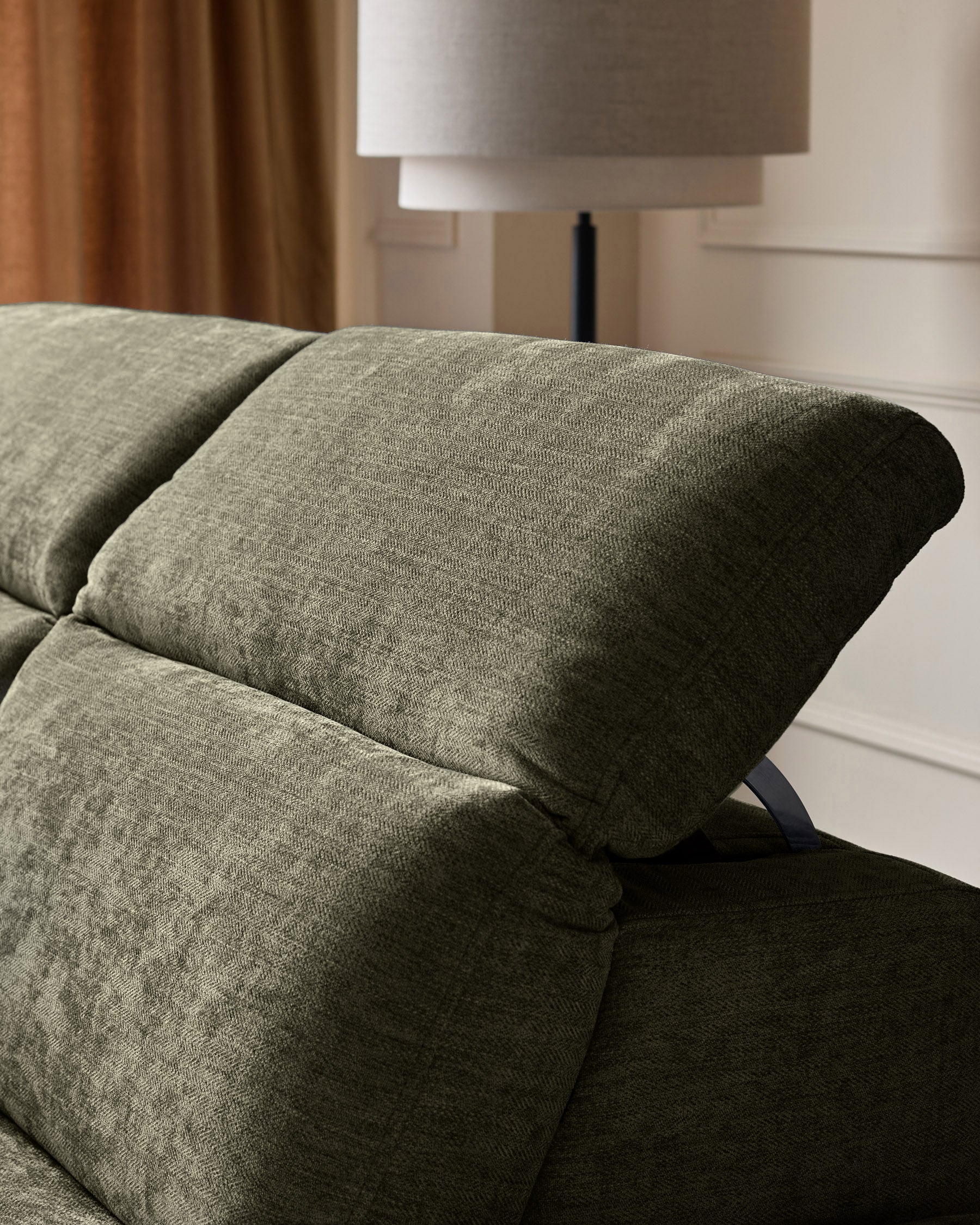 Serene left chaise recliner sofa in dark green chenille, close-up of rolled arm and cushioned seat detail.