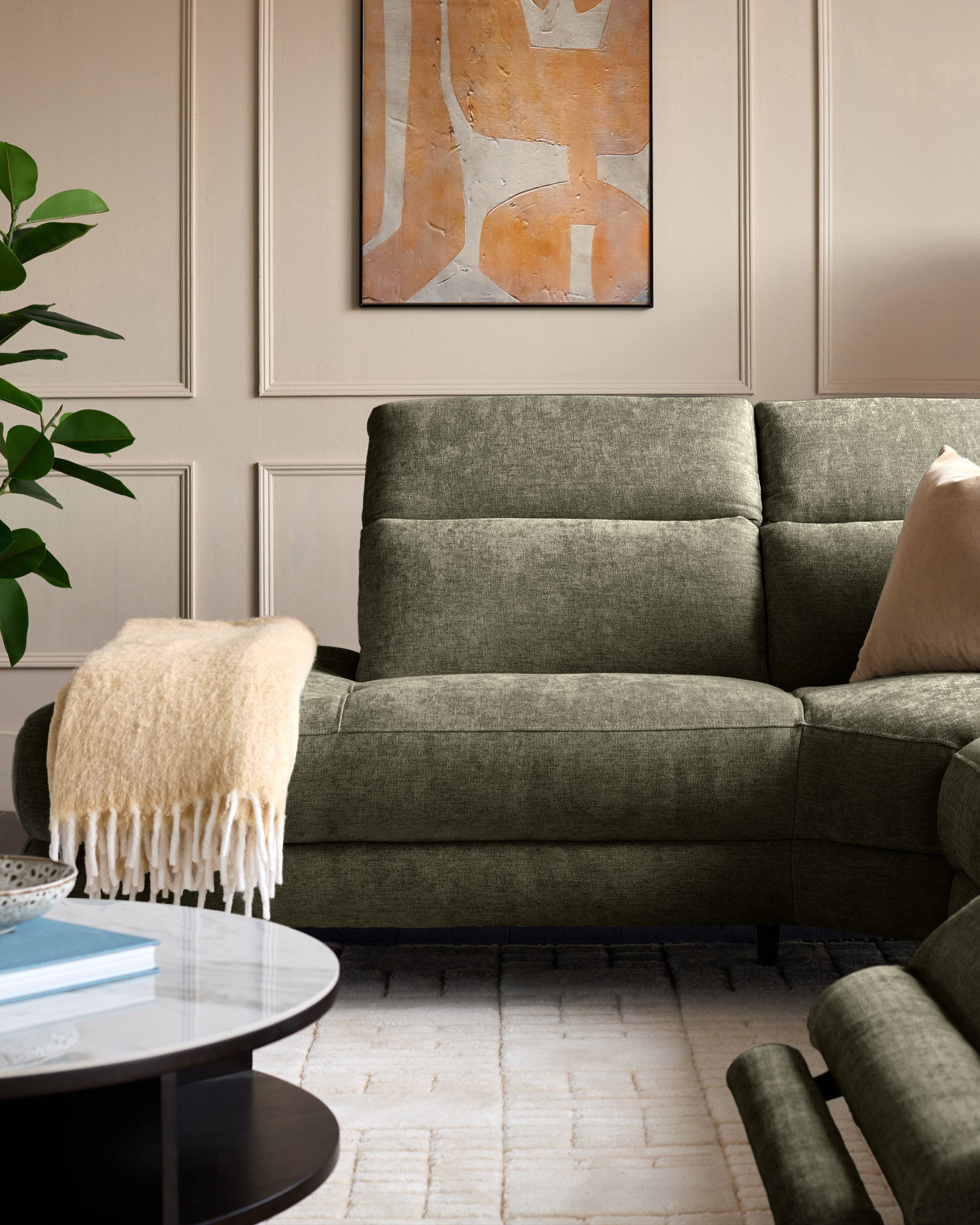 Serene left chaise recliner sofa in dark green chenille, shown in a modern living room setting with pillows and throw blanket.