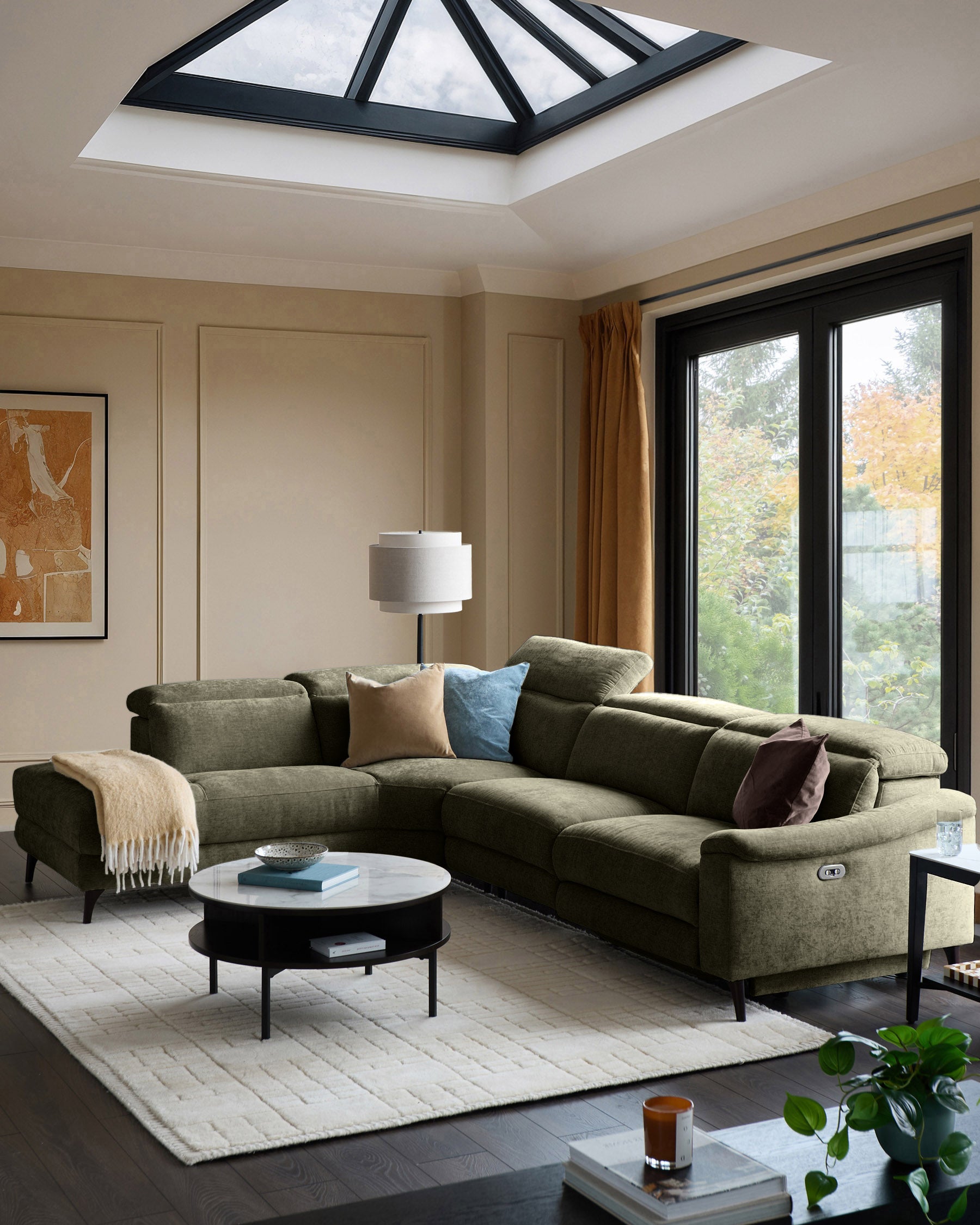 Serene left chaise recliner sofa in dark green chenille, displayed in a modern living room with skylight and garden views.