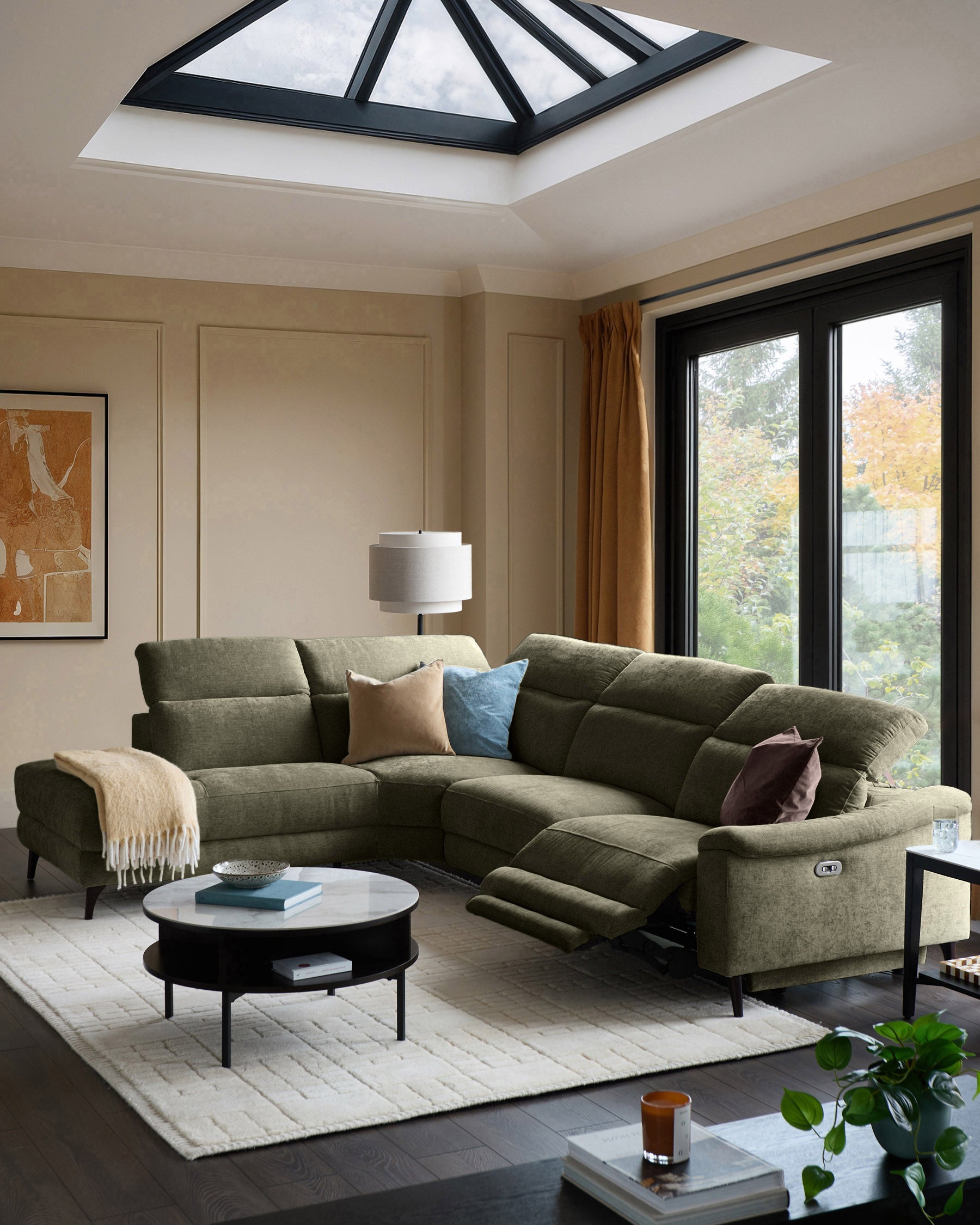 Serene left chaise recliner sofa in dark green chenille, displayed in a modern living room with extended footrest visible.