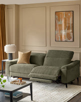 Dark green 3-seater fabric recliner sofa with extended footrests, shown in a contemporary living room setting.