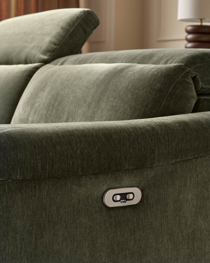 Dark green fabric left corner recliner sofa with control button visible on armrest, styled with cushions in neutral room setting.