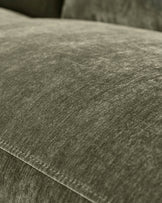 Close-up of dark green fabric texture on Serene left small corner recliner sofa, showing weave detail and stitching.