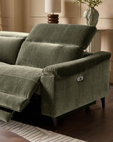 Dark green fabric left-corner recliner with rolled armrests, power recline button visible, angled view in neutral room setting.