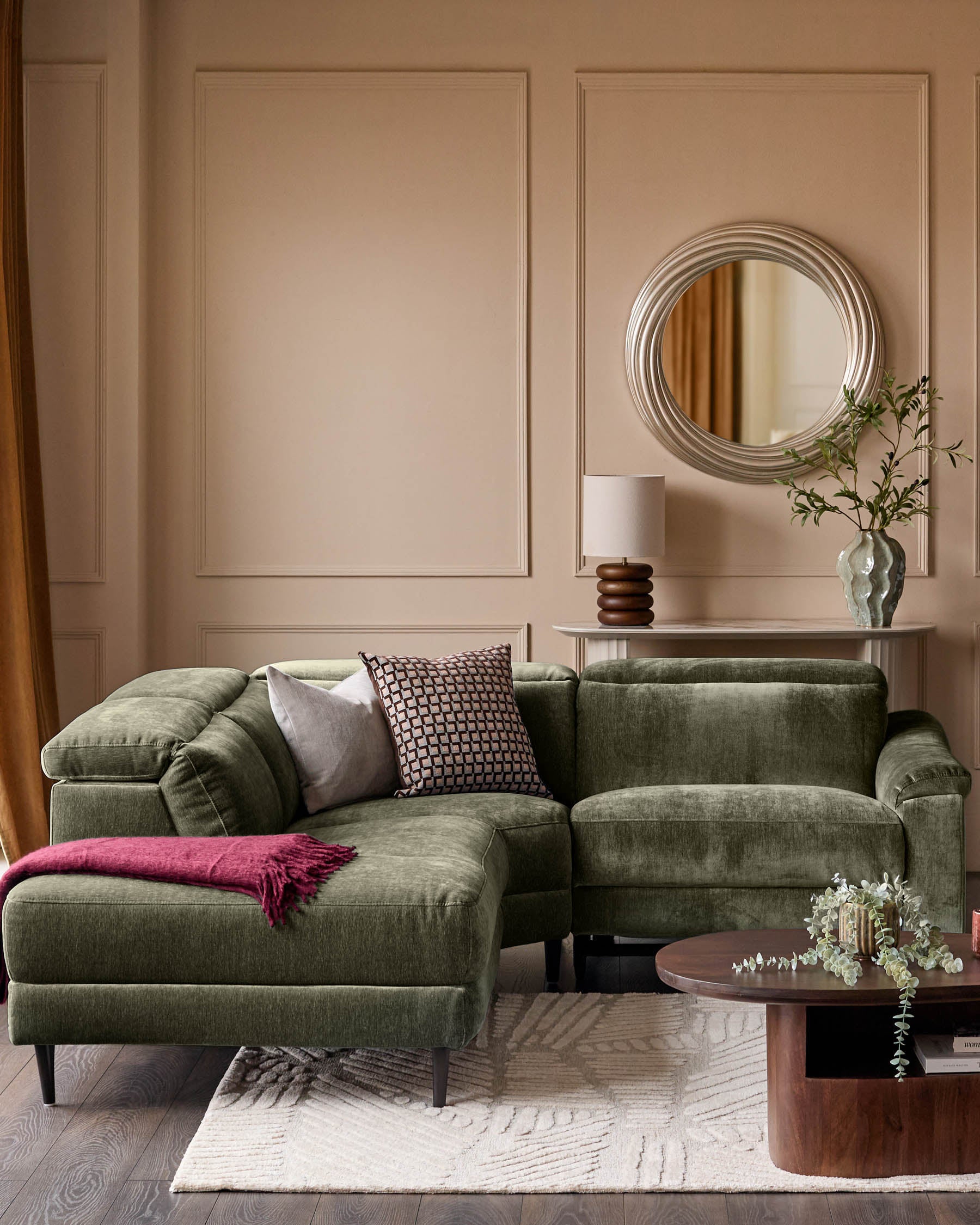 Serene left small corner recliner sofa in dark green fabric, displayed in a modern living room setting with neutral walls and wooden accents.