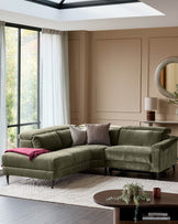 Serene left small corner recliner sofa in dark green fabric, displayed in a modern living room setting with neutral walls and natural lighting.