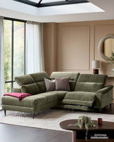 Serene left small corner recliner sofa in dark green fabric with reclined footrest, positioned in a modern living room with skylight.