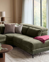 Dark green fabric right-corner recliner sofa with decorative pillows in a styled living room setting.