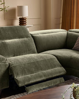 Serene right small corner recliner sofa in dark green fabric with footrest extended, shown in elegant room setting.