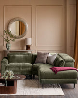 Dark green fabric right-hand corner recliner sofa with rolled arms, displayed in a contemporary living room setting with accent pillows and throw blanket.